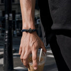 Blackened Black Mamba rope bracelet worn on a mans wrist