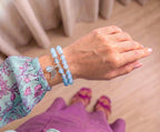 Light blue chalcedony beads worn in two wraps on the wrist with a floral sleeve