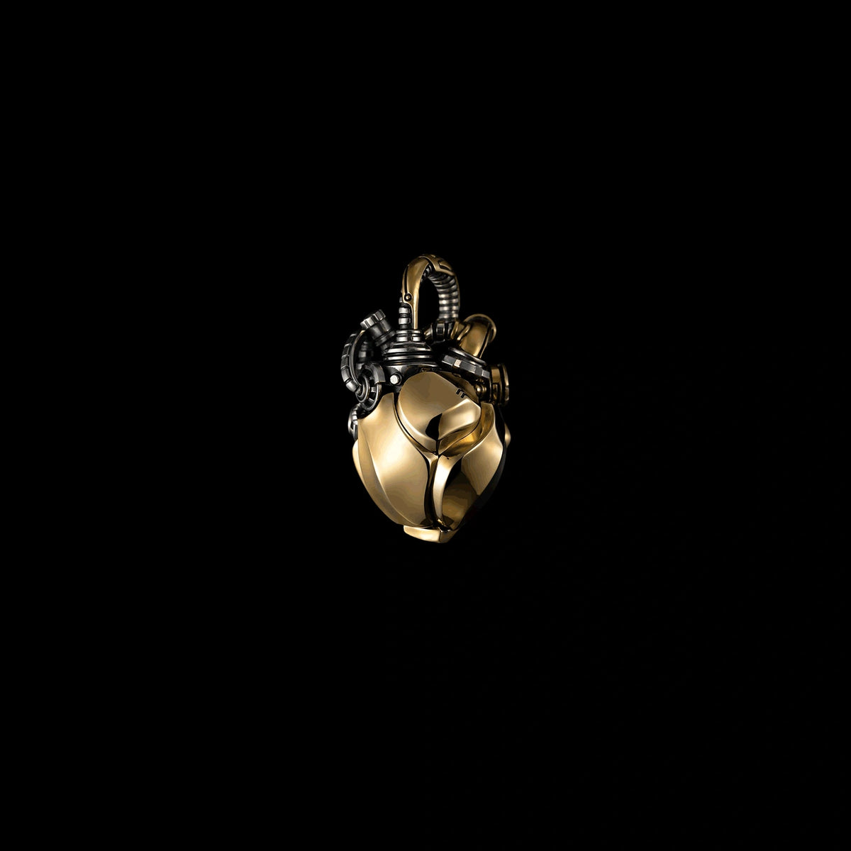Mechanical heart pendant in brass and white bronze