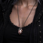 Close-up view of the Copper & White Bronze Mechanical Heart Pendant worn on a necklace