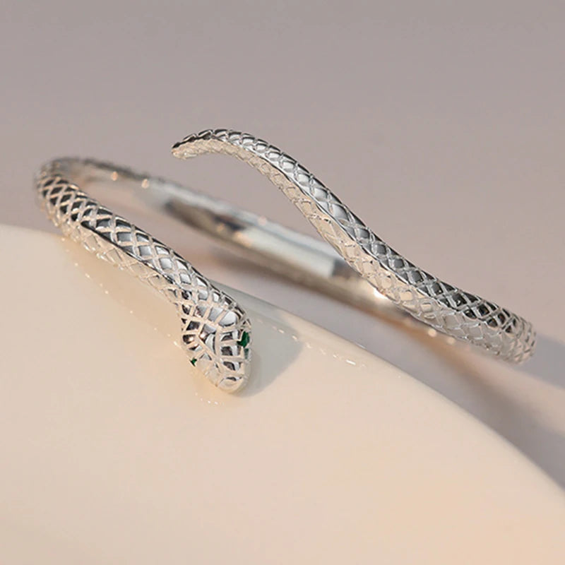 Close-up of the serpent head, green eye accents and textured scales