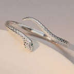 Close-up of the serpent head, green eye accents and textured scales