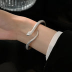 Serpent cuff bracelet styled with a black sleeve and white cuff