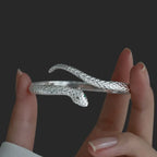 Side view of the open snake cuff showing its curved shape and scale texture