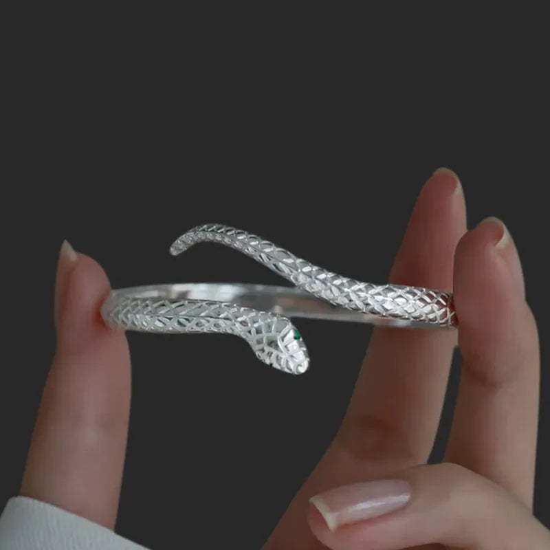Side view of the open snake cuff showing its curved shape and scale texture