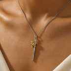 Two-tone hugging pendant necklace worn at the neckline