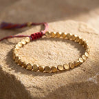 Detail of the red-brown sliding knot and textured metal beads