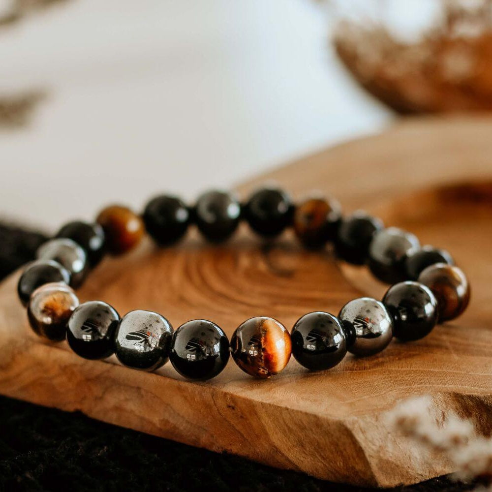 saltlume.com Triple Protection Bracelet with hematite, black obsidian and tiger's eye on a wooden display